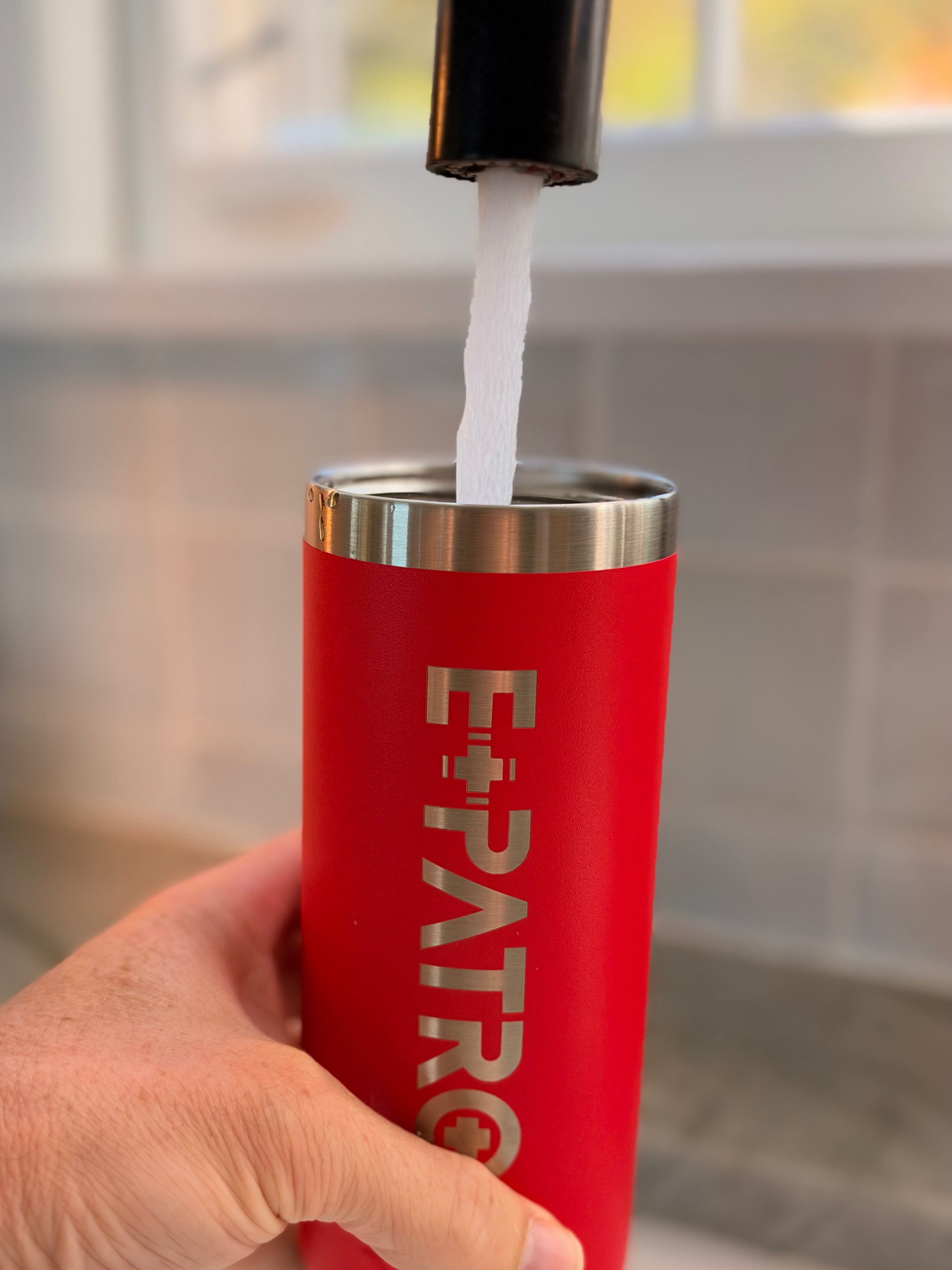 Water from a faucet filling a red E+PATROL Yeti waterbottle